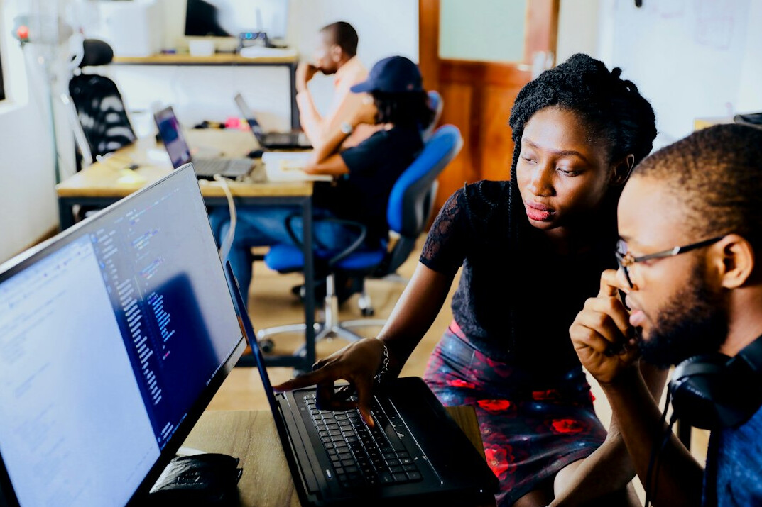 team discussing software code