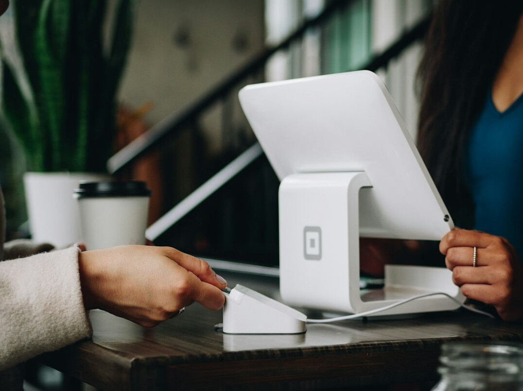 Two colleagues discussing an insurance claims workflow on a tablet