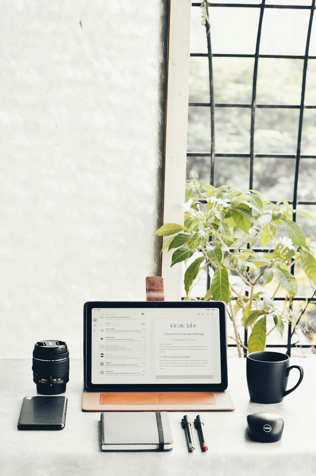 Desk with laptop showing an insurance analytics dashboard and a notebook