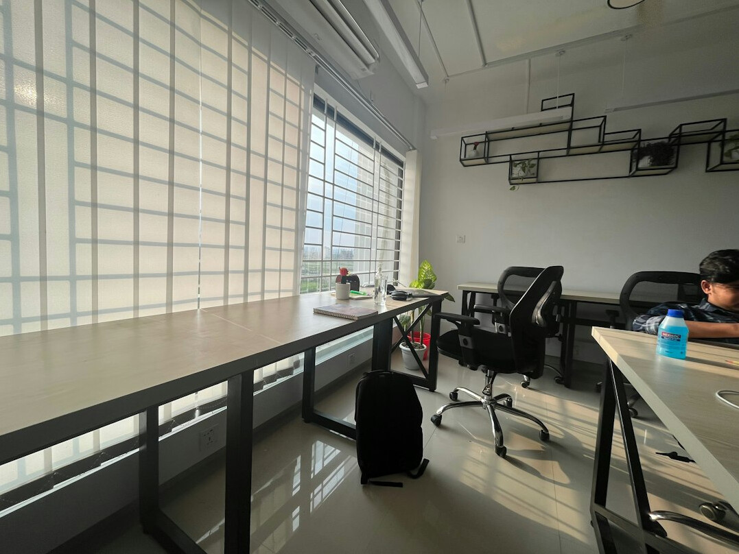 Modern open-plan office with developers working on multiple monitors
